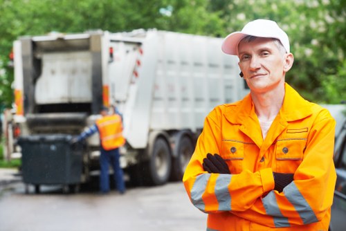 Construction site with builders managing waste